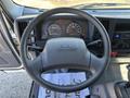 Dashboard and steering wheel of a 2016 Isuzu NPR-HD with gauges and controls visible