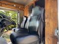 Interior of a 2008 Workhorse W62 with three black leather seats visible from the driver's perspective