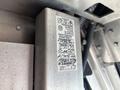 A metal label with printed and handwritten information about a 2018 Ford Econoline vehicle identification and specifications