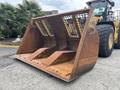 A rusted bucket attachment for a 2012 Caterpillar 980 loader with a grid design on the front and two large openings for material movement